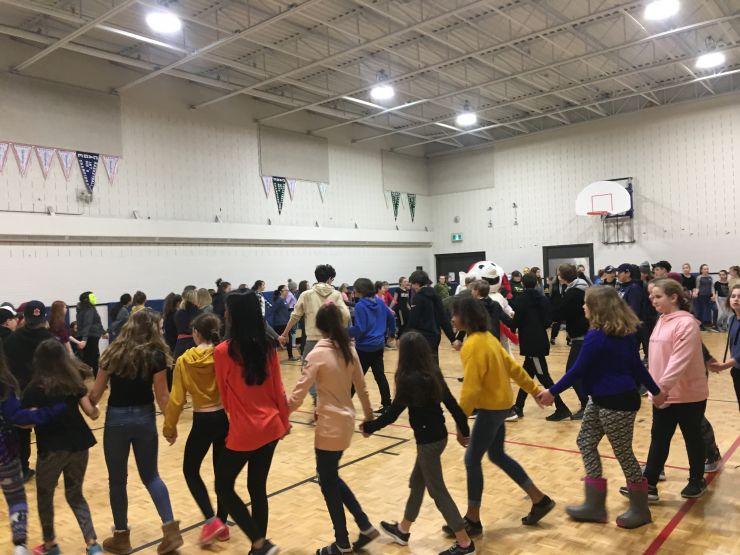 Students dance in a gym