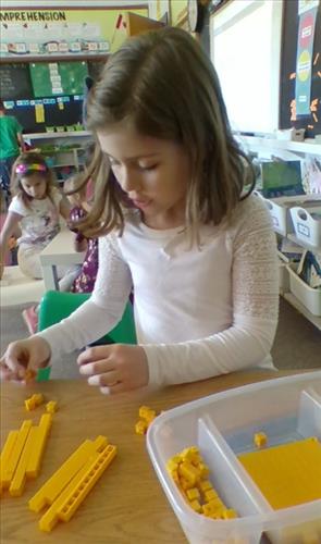 A female student works with math manipulatives