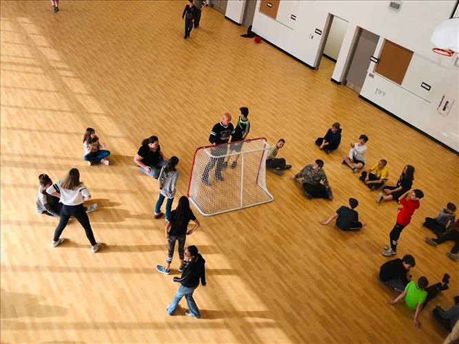 Students play a game in a gym