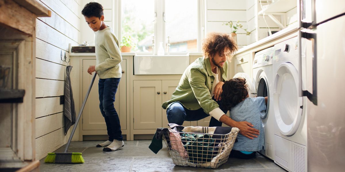 Dad with two kids doing house chores