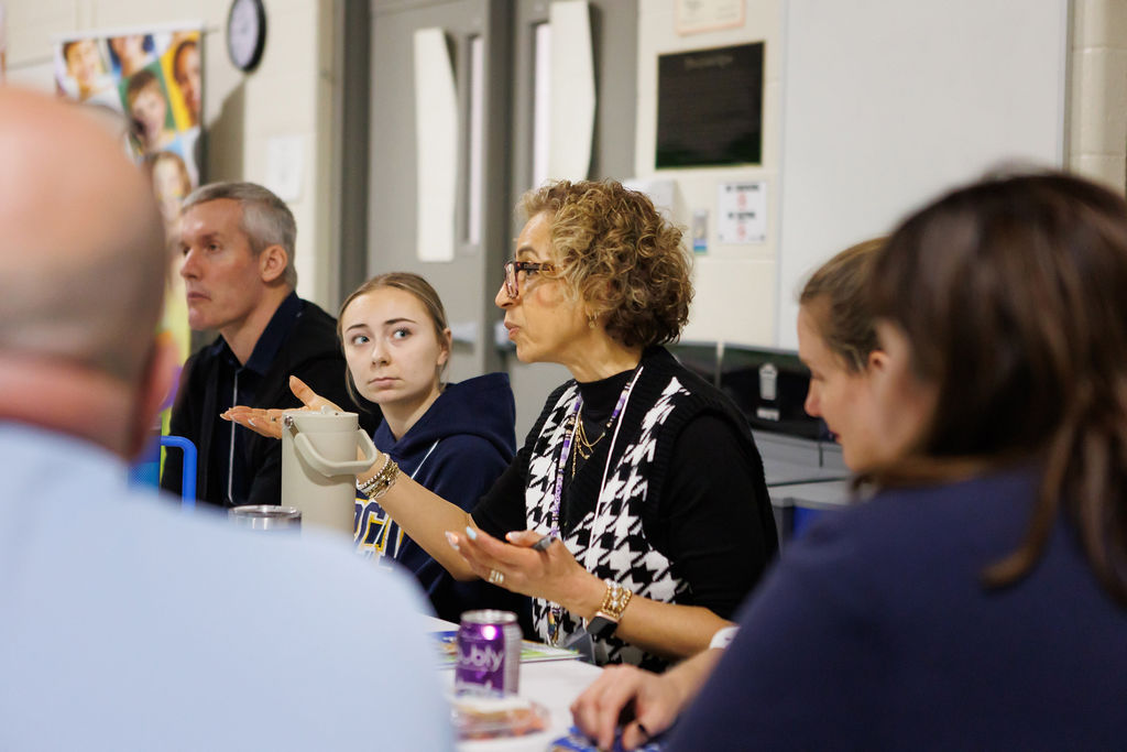 Group of people at group table engaged in discussion