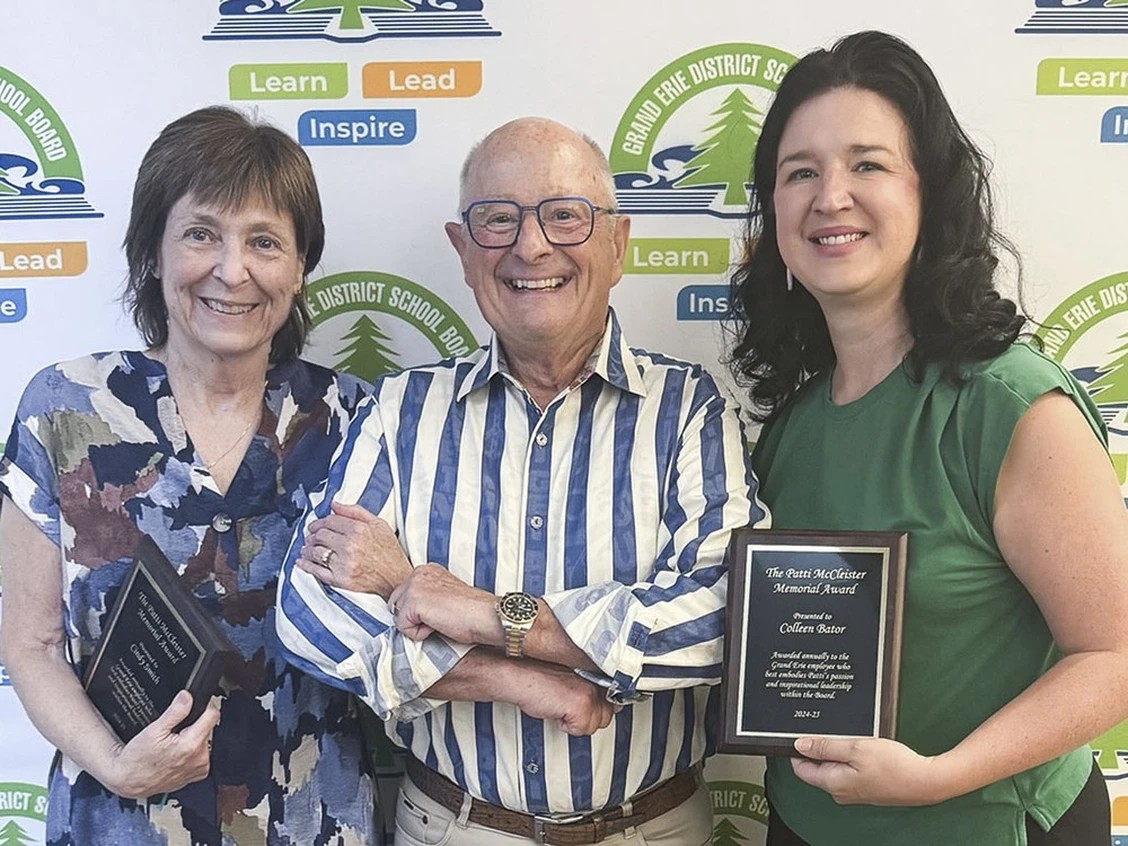 Delhi District Secondary School teacher Colleen Bator, right, and Cindy Smith, left, manager of business services with the Grand Erie District School Board, each receive the Patti McCleister Memorial Award during a recent school board meeting. 