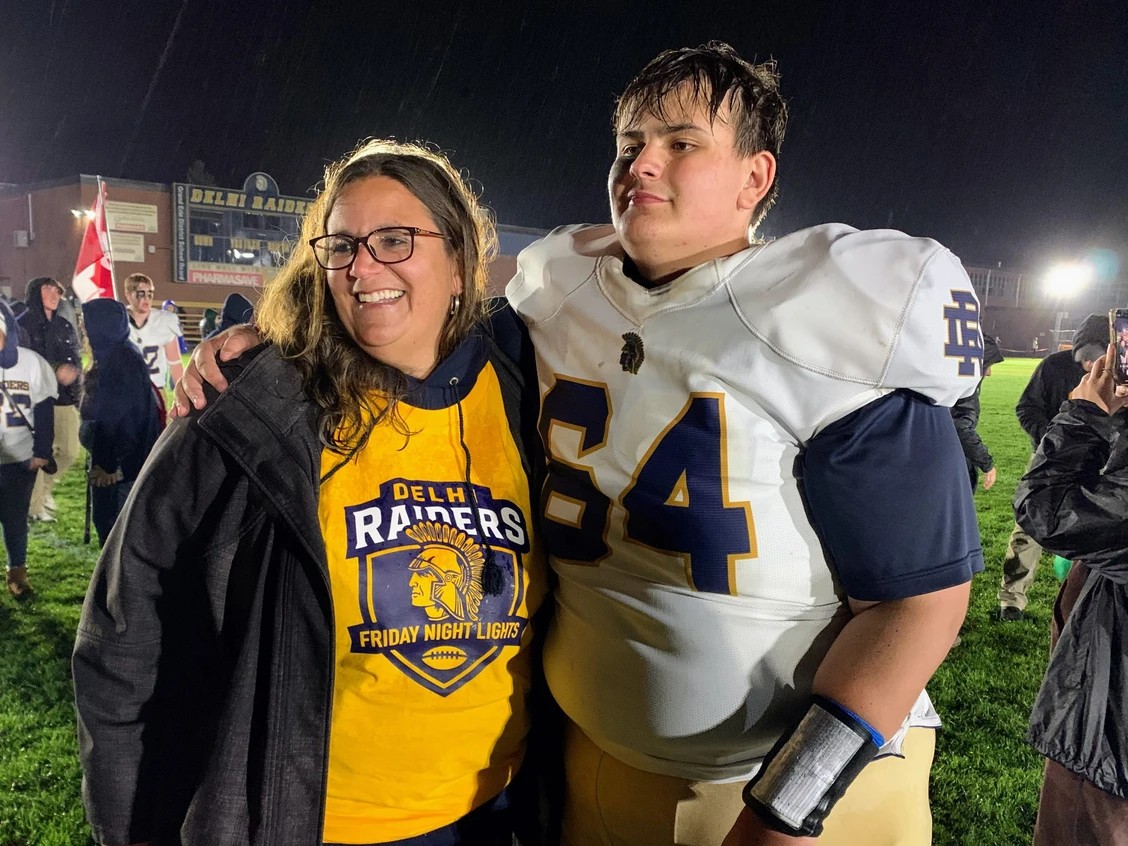 Delhi Raiders lineman Reid Wouters poses for a photo with his mother Melissa following the Friday Night Lights contest at DDSS on Oct. 10. The Raiders won the game by a score of 62-6. Photo by Jacob Robinson
