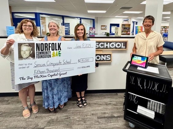 McKiee-grant-SCS A special presentation at Simcoe Composite School included Marleen Van De Wiele, head of library services, Trish Misner, the liaison for the Norfolk Community Foundation, Jen Ippolito, the SCS principal and Jane Cowan, daughter of the late Jay McKiee